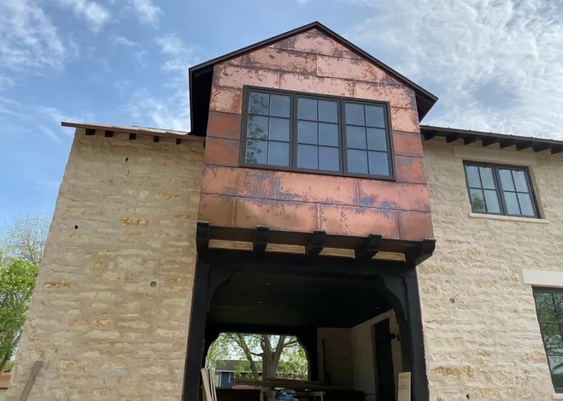 Copper metal panel facade on a stone building for Metal Roof Coating in Bee Cave